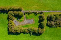 AERIAL ART - green fields and paved area surrounded by trees - near Niederkassel - Germany