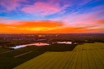 AERIAL ART - rapeseed field and flooded gravel pit with Niederkassel and Rhine river in the back during sunset - Germany 02 AERIAL ART - rapeseed field and flooded gravel pit with Niederkassel and Rhine river in the back during sunset - Germany 02