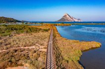 AERIAL ART - wooden footbridge between ponds behind Porto Taverna beach and Isola Tavolara in the back - Sardinia - Italy 02 AERIAL ART - wooden footbridge between ponds behind Porto Taverna beach and Isola Tavolara in the back - Sardinia - Italy 02.jpg