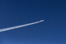 Airliner with vapor trail in blue skies Airliner with vapor trail in blue skies