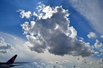 TAIL OF LUFTHANSA CARO BOEING B777 AND SUNLIGHTED CLOUDS TAIL OF LUFTHANSA CARO BOEING B777 AND SUNLIGHTED CLOUDS