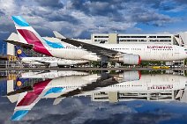 Eurowings Airbus A330 parked in Frankfurt EDDF mirroring in a rain puddle - Gerrmany Eurowings Airbus A330 parked in Frankfurt EDDF mirroring in a rain puddle - Gerrmany.jpg