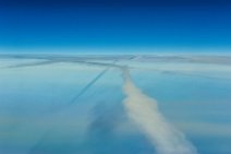 Above vapor trails in blue sky Above vapor trails in blue sky.JPG