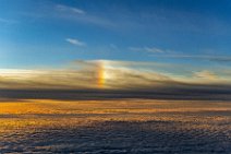 Sunset over the clouds - with rainbow colored reflections Sunset over the clouds - with rainbow colored reflections