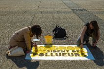 Activists painting Macron - president of polluters lettering in La Defense - Paris - France Activists painting Macron - president of polluters lettering in La Defense - Paris - France.jpg