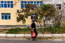 Woman apssing an apartment block - Ashgabat - Turkmenistan Woman apssing an apartment block - Ashgabat - Turkmenistan