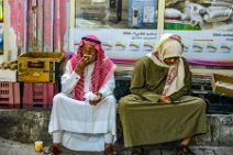 Two men eating in the streets of Manamah - Bahrain Two men eating in the streets of Manamah - Bahrain