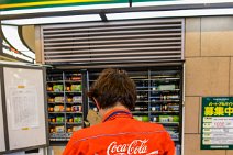 Coca Cola employee refilling a vending machine - Tokyo - Japan Coca Cola employee refiling a vending machine - Tokyo - Japan