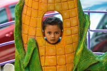 Little boy looking through a corn cob - Malaysia Little boy looking through a corn cob - Malaysia