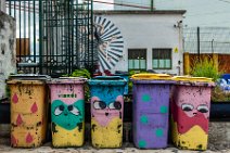 Funny faces on colorful painted trash barrels - Lisbon - Portugal Funny faces on colorful painted trash barrels - Lisbon - Portugal